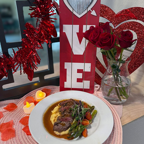 Valentine's Candlelight Dinner display featuring chef-prepared steak dinner.